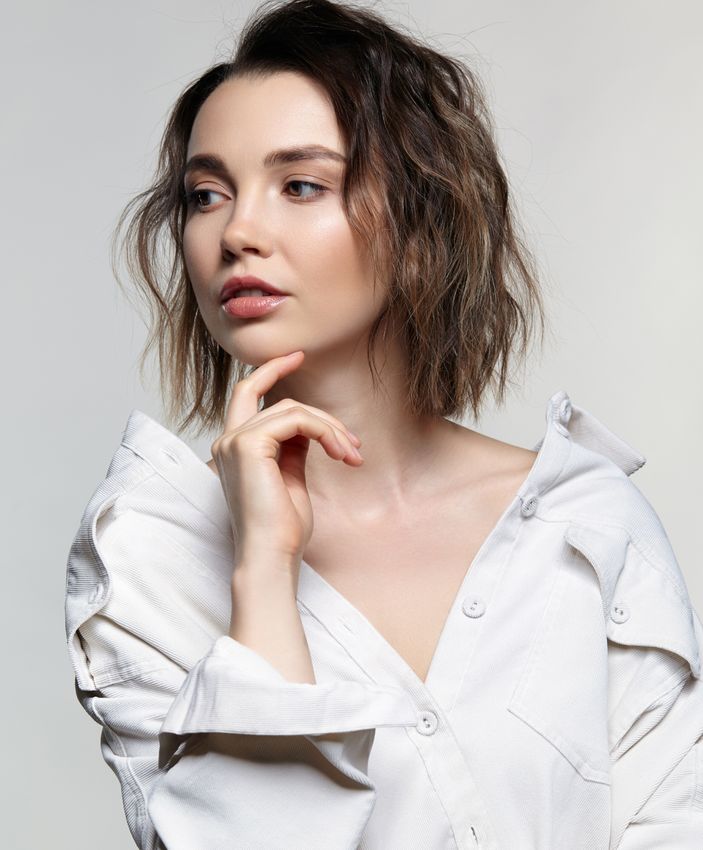 Newton Rosacea Treatment model with short hair in white shirt.